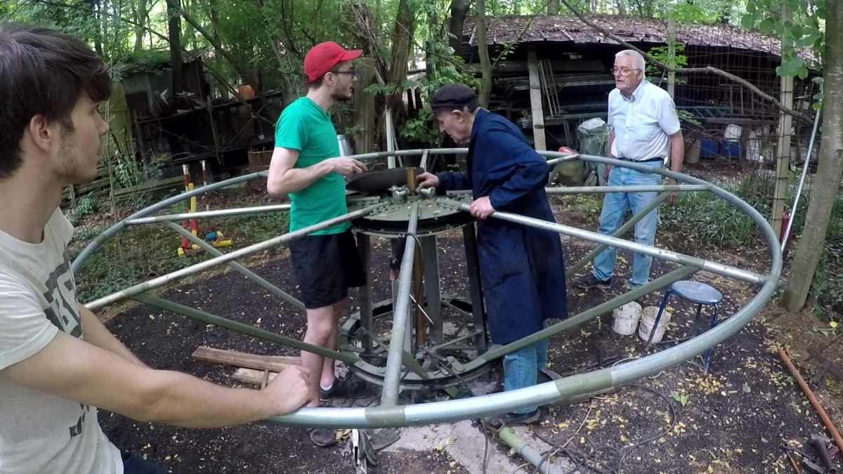 Here Bruno is doing repair work and adjustment on the hub for human propulsion while his two grandsons give a hand.