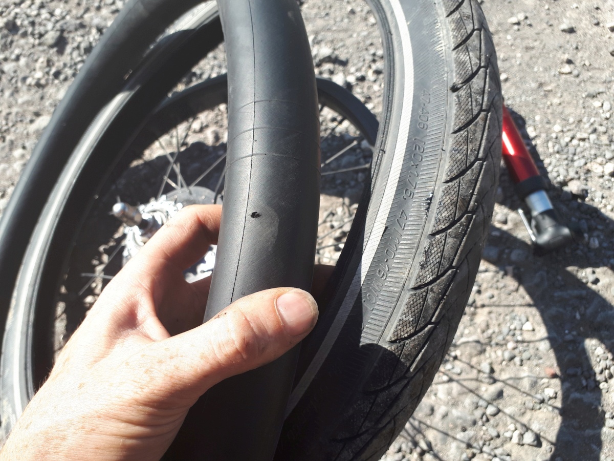 Our schwalbe marathon plus tires were not as puncture proof as we had hoped. In this case, a small wire had worked it's way through the outer layer and the anti--puncture strip and was poking inside the tire just enough to abrade a hole in the thick inner tube.