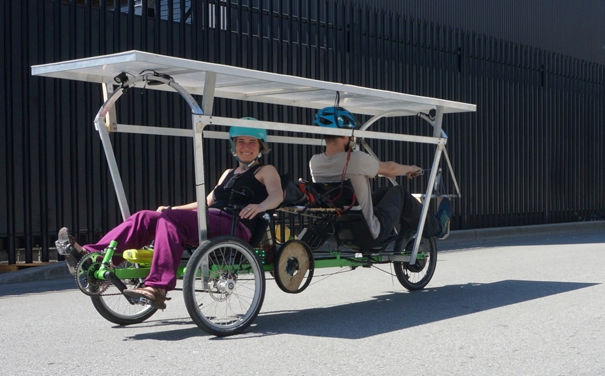 Justin and AnSo's first test ride with a solar roof and the 2nd row rig system. Note that the tilting mechanism for the roof has not been built yet, it is fixed.