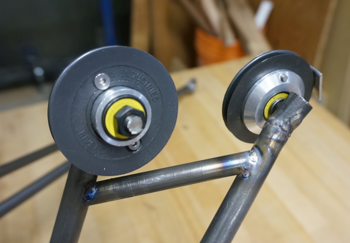 We purchased blank pulleys from Mcmaster-Carr at the suggestion of ES users, which had a nice deep groove for the string slot. We then machined our own ball bearing hubs.